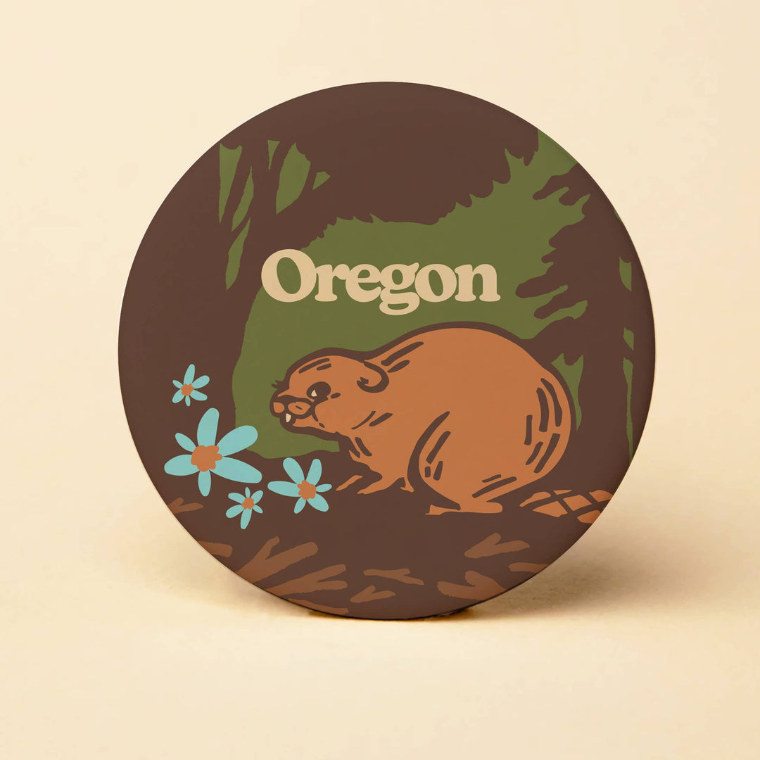 Round sticker with beaver illustration and 'Oregon' text on a beige background
