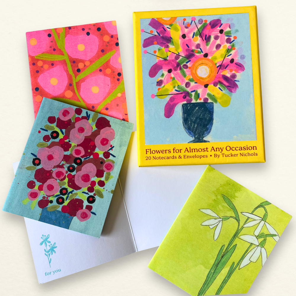 Set of colorful floral notecards and envelopes on a white background