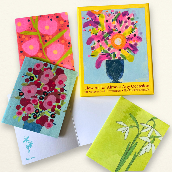 Set of colorful floral notecards and envelopes on a white background